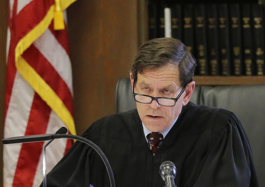 Judge Jeffrey Locke listens as assistant district attorney Patrick Haggan delivers his opening statement to the jury on he first day of former New England Patriots tight end Aaron Hernandez's double murder trial at Suffolk Superior Court on Wednesday, March 1, 2017, in Boston. Hernandez is standing trial for the July 2012 killings of Daniel de Abreu and Safiro Furtado who he encountered in a Boston nightclub. He is already serving a life sentence in the 2013 killing of semi-professional football player Odin Lloyd. (AP Photo/Stephan Savoia, Pool)
