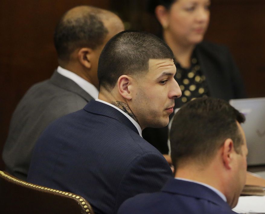 Former New England Patriots tight end Aaron Hernandez sits with his attorneys Jose Baez, right, and Ronald Sullivan, left, at the opening of the fist day of his double murder trial at Suffolk Superior Court on Wednesday, March 1, 2017, in Boston. Hernandez is standing trial for the July 2012 killings of Daniel de Abreu and Safiro Furtado who he encountered in a Boston nightclub. He is already serving a life sentence in the 2013 killing of semi-professional football player Odin Lloyd. (AP Photo/Stephan Savoia, Pool)
