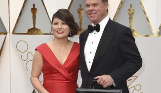 FILE - This Feb. 26, 2017 file photo shows Martha L. Ruiz, left, and Brian Cullinan from PricewaterhouseCoopers at the Oscars in Los Angeles.  Film academy president Cheryl Boone Isaacs says the two accountants responsible for the best picture mistake will not work the Oscars again. Cullinan and Ruiz were responsible for the winners’ envelopes at Sunday’s Oscar show. Cullinan tweeted a photo of Emma Stone from backstage minutes before handing presenters Warren Beatty and Faye Dunaway the wrong envelope for best picture. Boone Isaacs said Cullinan’s distraction caused the error.  (Photo by Jordan Strauss/Invision/AP, File)