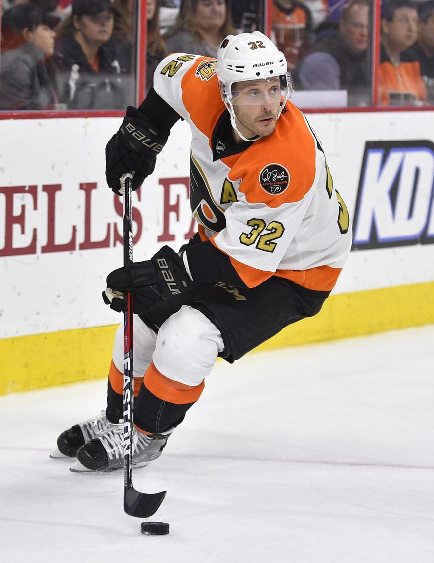 ADDS THAT STREIT SENT TO PENGUINS AFTER TRADED TO LIGHTNING - FILE - In this Nov. 2, 2016, file photo, Philadelphia Flyers' Mark Streit skates with the puck during an NHL hockey game against the Detroit Red Wings in Philadelphia. The Pittsburg Penguins sent a fourth-round pick in the 2018 draft to the Tampa Bay Lightning for Streit, just hours after the Lightning acquired Streit from Philadelphia on Wednesday, March 1, 2017. (AP Photo/Derik Hamilton, File)