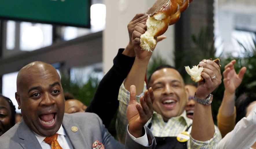 Newark Mayor Ras Baraka, left, reacts as employees of Whole Foods supermarket cut bread as part of a grand opening ceremony of the store, Wednesday, March 1, 2017, in Newark, N.J. (AP Photo/Julio Cortez)