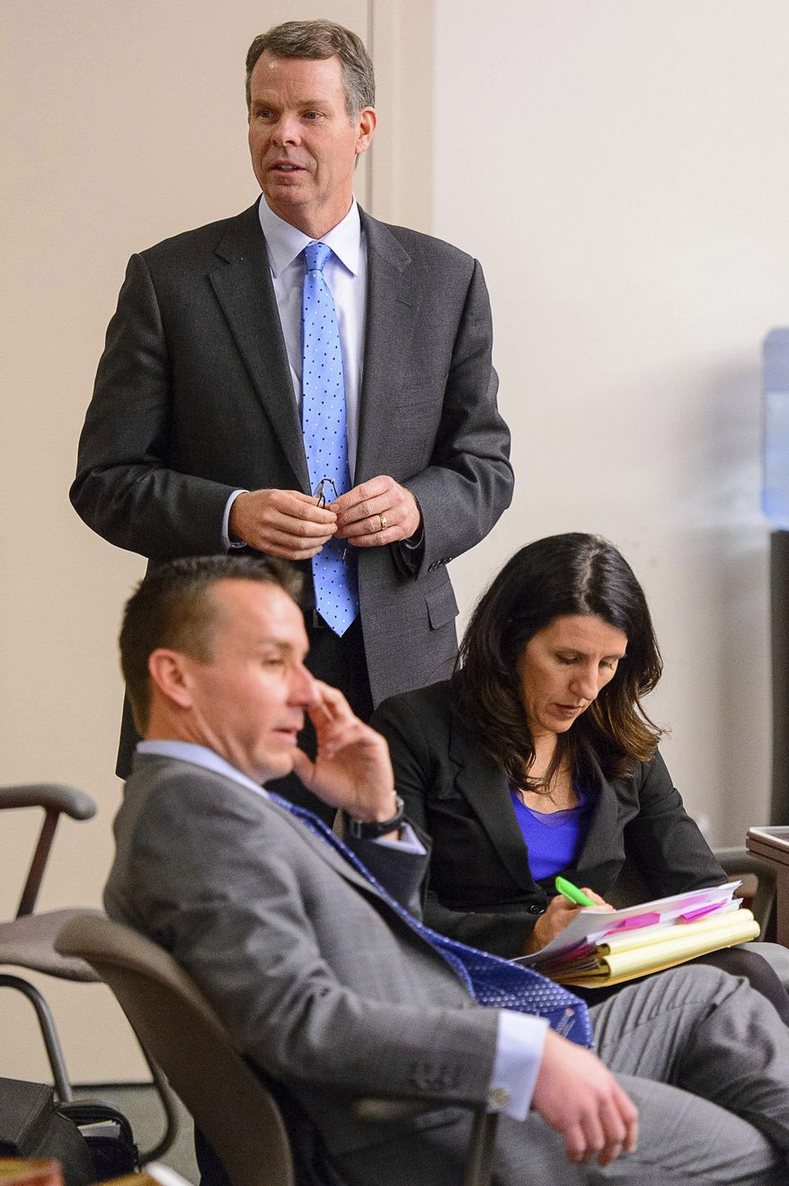 Former Utah Attorney General John Swallow, back, stands during his trial as defense attorneys Brad Anderson and Cara Tangaro look in Salt Lake City, Tuesday, Feb. 28, 2017. Attorneys for Swallow presented a brief defense Tuesday as one of the biggest political scandals in state history sped toward jury deliberations. (Trent Nelson/The Salt Lake Tribune via AP, Pool)