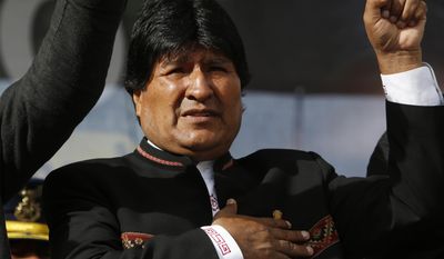 FILE - In this Feb. 22, 2016 file photo, Bolivia&#x27;s President Evo Morales sings his national anthem at a signing ceremony for the expansion of a road that connects the capital with the nearby city of El Alto, in La Paz, Bolivia. Bolivia’s government says Morales went to Cuba on Wednesday, March 1, 2017 for emergency treatment of a persistent throat problem following “major complications.” (AP Photo/Juan Karita, File)