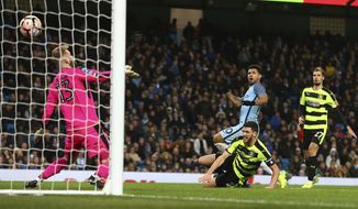 Manchester City&#x27;s Sergio Aguero, center, scores his side&#x27;s fourth goal during the English FA Cup soccer match between Manchester City and Huddersfield Town at the Etihad stadium in Manchester, Wednesday, March 1, 2017.(AP Photo/Dave Thompson)