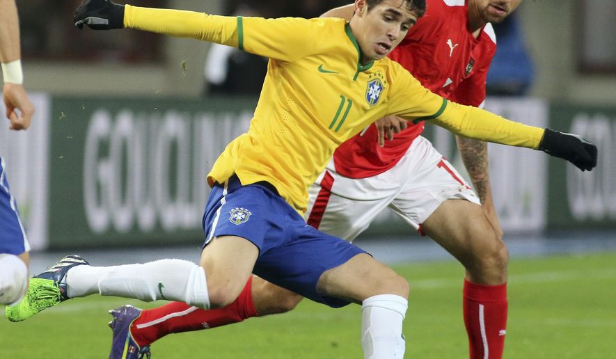 FILE - In this Nov. 18, 2014 file photo, Brazil's Oscar, left, and Austria's Martin Harnik fight for the ball during an international friendly soccer match in Vienna, Austria. For a second successive winter transfer window, the Chinese Super League has upset the established world soccer order with the spending power and ambition of its biggest clubs. It started in December as Shanghai SIPG agreed to pay $60 million to Chelsea for Brazil's Oscar in a move that prompted Antonio Conte, coach of the Premier League club, to warn about the challenge from the east. (AP Photo/Ronald Zak, File)