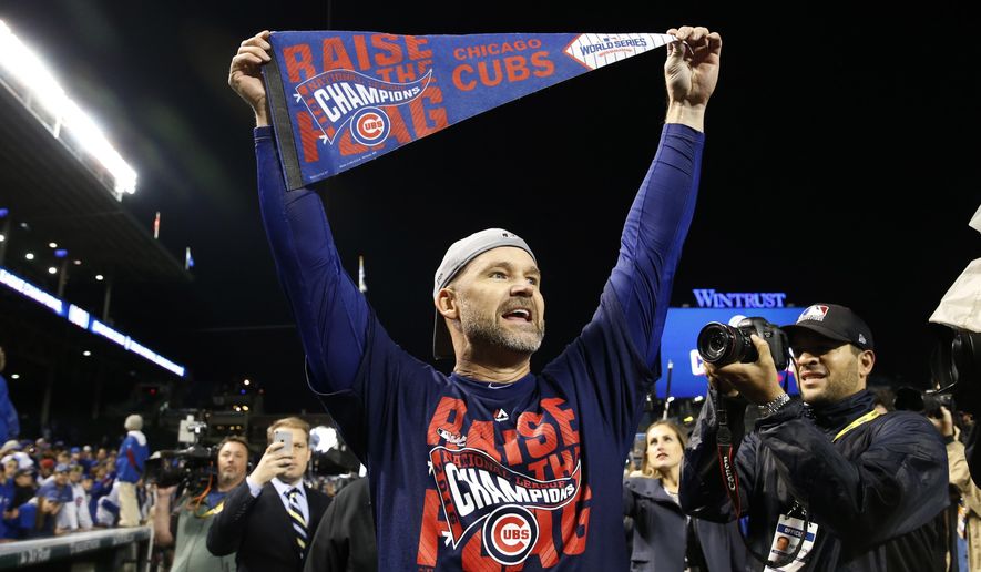 FILE - In this Oct. 22, 2016, file photo, Chicago Cubs catcher David Ross celebrates after Game 6 of the National League baseball championship series against the Los Angeles Dodgers in Chicago. Ross, who retired after helping the Cubs win the World Series last year, is part of the 24th season of  “Dancing with the Stars,” and his former teammates are excited to watch the ex-catcher on the show.  (AP Photo/Nam Y. Huh, File)