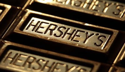 FILE - This July 25, 2011, file photo shows Hershey&#39;s chocolate in Overland Park, Kan. Hershey Co. expects to cut 15 percent of its global hourly workforce, primarily outside the United States. The Pennsylvania-based company says chief executive Michele Buck will have more to say on the plan when she briefs analysts in New York on Wednesday, March 1, 2017. Hershey operates eight factories outside the U.S. (AP Photo/Charlie Riedel, File)
