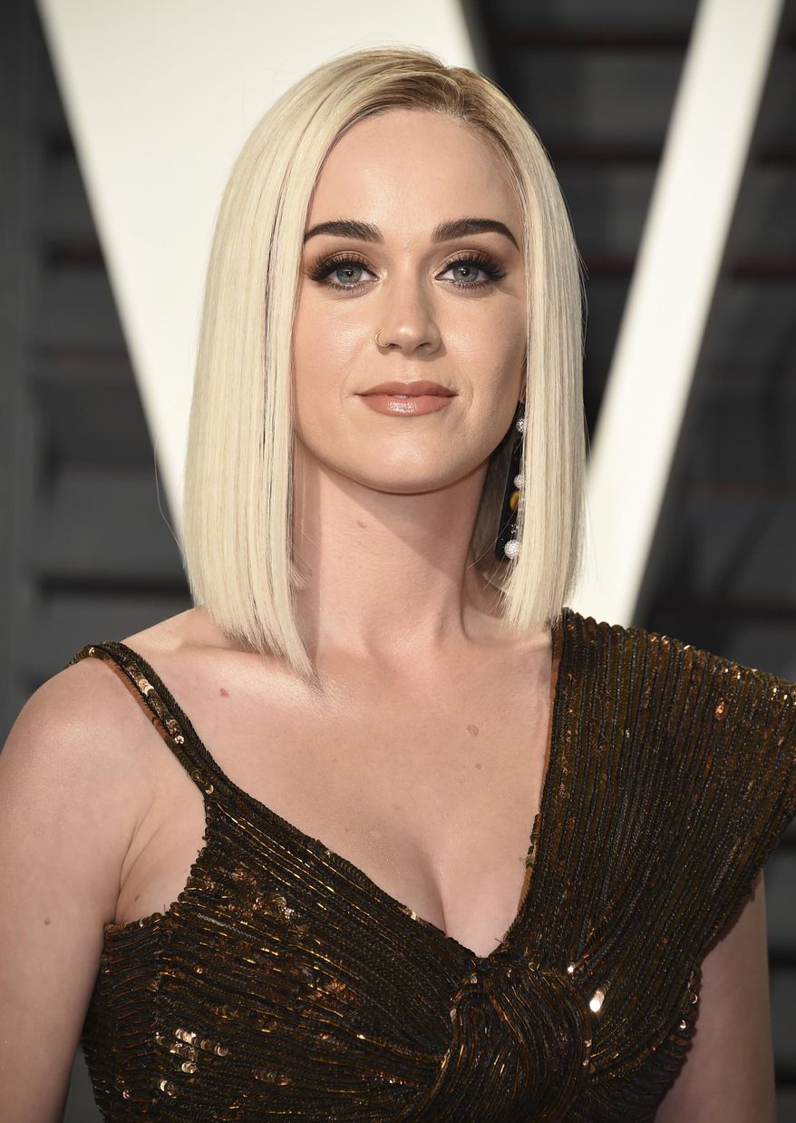 FILE - This Feb. 26, 2017 file photo shows Katy Perry at the Vanity Fair Oscar Party in Beverly Hills, Calif. Perry and actor Orlando Bloom are breaking up after about a year together. Representatives for Perry and Bloom released a statement Wednesday saying: “... we can confirm that Orlando and Katy are taking respectful, loving space at this time.” (Photo by Evan Agostini/Invision/AP, File)