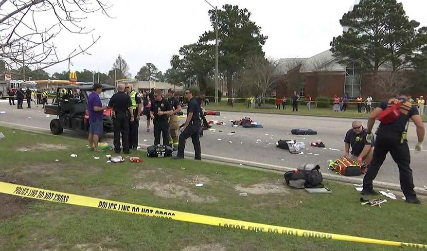 In this image made from a video provided by FOX10 News authorities investigate the scene after an SUV driven by a 73-year-old man accelerated and hit members of a high school band at the start of a Mardi Gras parade in Gulf Shores, Ala., Tuesday, Feb. 28, 2017. (Franz Barraza/FOX10 News via AP) MANDATORY CREDIT