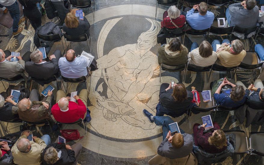 Members of the audience sit in the Rotunda of the State Capitol during a ceremony to unveil a new Nebraska statehood forever stamp, one of several ceremonies taking place in Lincoln, Neb., Wednesday, March 1, 2017, to mark the 150th anniversary of the State of Nebraska. (AP Photo/Nati Harnik)