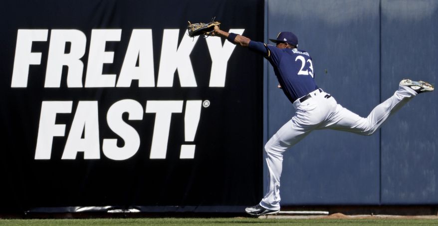 Milwaukee Brewers' Keon Broxton makes a running catch during a spring training baseball game against the Cincinnati Reds Wednesday, March 1, 2017, in Phoenix. (AP Photo/Morry Gash)