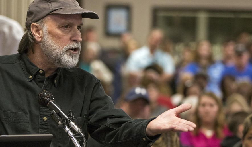 In this Tuesday, Feb. 28, 2017 photo, Shawn Shea of Crescent, an opponent of the Council Bluffs Community School District's proposal to close Crescent Elementary School, makes a plea to the school board to keep the school open during a meeting, in Council Bluffs, Iowa. On a 5-2 vote, the school board voted down the district's proposal to close the elementary school in the small Pottawattamie County community that would have sent students to Lewis and Clark Elementary School in Council Bluffs. (Joe Shearer /The Daily Nonpareil via AP)