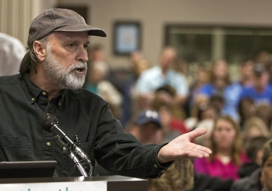 In this Tuesday, Feb. 28, 2017 photo, Shawn Shea of Crescent, an opponent of the Council Bluffs Community School District's proposal to close Crescent Elementary School, makes a plea to the school board to keep the school open during a meeting, in Council Bluffs, Iowa. On a 5-2 vote, the school board voted down the district's proposal to close the elementary school in the small Pottawattamie County community that would have sent students to Lewis and Clark Elementary School in Council Bluffs. (Joe Shearer /The Daily Nonpareil via AP)