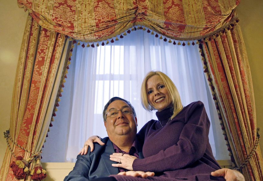 Martin Murphy and Rebecca Ward of Orlando, Fla., pose for a photograph in their room at the Waldorf Astoria hotel, Tuesday, Feb. 28, 2017, in New York. Two hotel regulars, Ward, 50, and her fiance, Murphy, 51, returned for two days this week to celebrate their engagement. Murphy proposed to Ward in front of the hotel's giant lobby clock one month ago. (AP Photo/Kathy Willens)