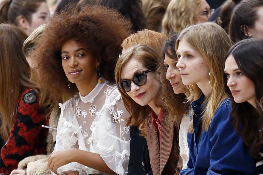 U.S singer Solange Knowles, left, and french actress Isabelle Huppert, second left, look on prior to the show for Chloe's Fall-Winter 2017-2018 ready to wear fashion collection presented in Paris, Thursday, March 2, 2017. (AP Photo/Francois Mori)