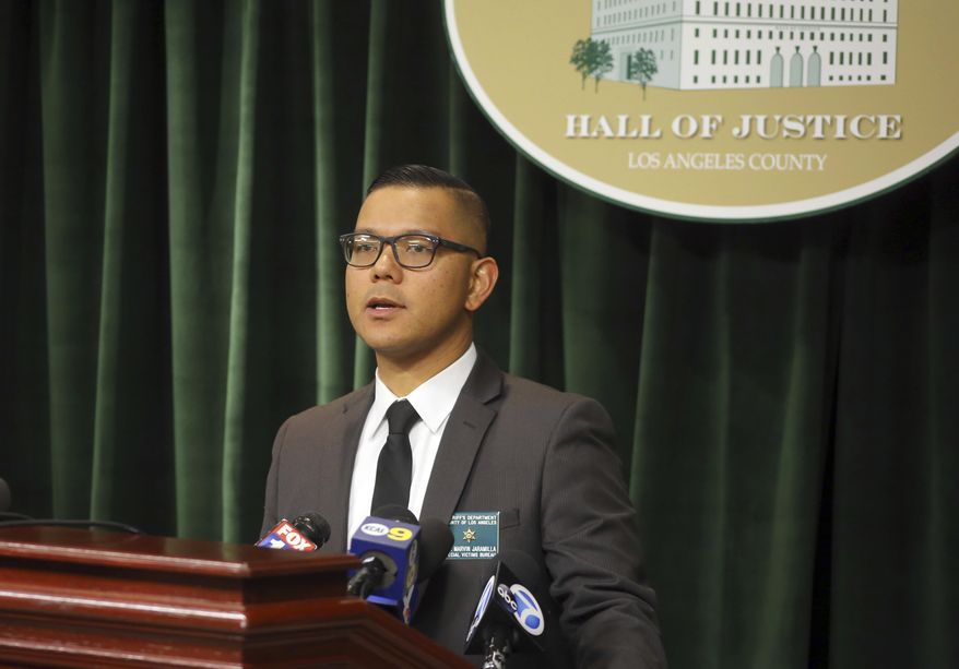 Los Angeles Sheriff's Det. Sgt. Marvin Jaramilla announces Thursday, March 2, 2017, that a California college football player convicted of sexual assault as a teenager has been arrested on suspicion of raping his physical therapist. Jaramilla said Kishawn Holmes is suspected of sexually assaulting the 19-year-old victim. He said the victim is a fellow student at Cerritos College. (AP Photo/Michael Balsamo)