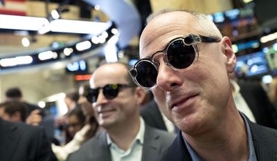 Snap employees Mark Randall, left, vice president of operations, and Steve Horowitz, vice president of engineering, wear Snap&#39;s Spectacles during the company&#39;s Wall Street debut at the New York Stock Exchange, Thursday, March 2, 2017. (AP Photo/Mark Lennihan)