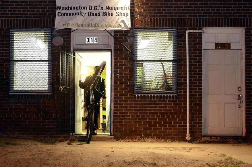 In a Thursday, Feb. 16, 2017 photo, DaiQuan Medley, 19, the senior youth mechanic, leaves Gearin' Up Bicycles after work, in northeast Washington, D.C. The non-profit bike shop, founded in 2012, gives career development opportunities and teaches essential workplace skills to teenagers from underserved communities. Marshall started volunteering at the bike shop in November 2015 and then became a staff youth mechanic in June 2016. (Rebecca Droke/Pittsburgh Post-Gazette via AP)
