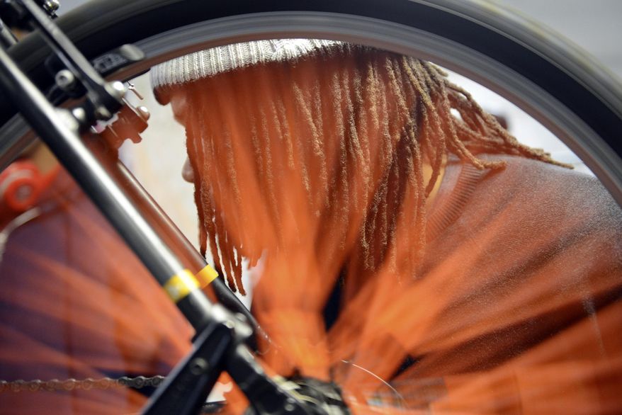 In a Thursday, Feb. 16, 2017 photo, youth mechanic Theodis Marshall, 16, works on adjusting the breaks on a bicycle, at Gearin' Up Bicycles in northeast Washington, D.C. The non-profit bike shop, founded in 2012, gives career development opportunities and teaches essential workplace skills to teenagers from underserved communities. Marshall started volunteering at the bike shop in November 2015 and then became a staff youth mechanic in June 2016. (Rebecca Droke/Pittsburgh Post-Gazette via AP)