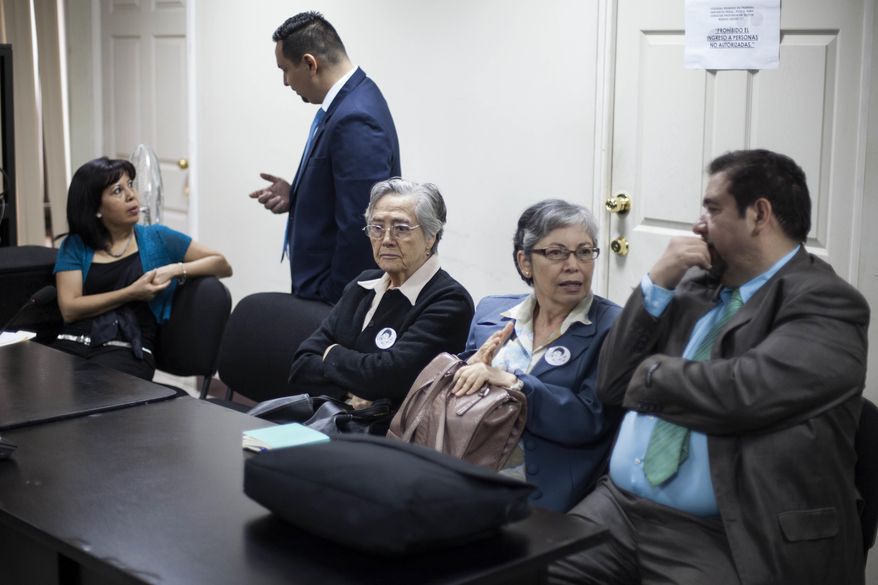 Emma Theissen, mother of the disappeared victim Marco Antonio Molina Theissen, center, accompanied by her daughter Ana Lucrecia, second from right, wait for a hearing at a courtroom in Guatemala City, Thursday, March 2, 2017. Five high-ranking military officers will stand trial for the kidnapping and disappearance of 14-year-old boy Marco Antonio Molina Theissen and the illegal detention, torture and rape of his sister in 1981. (AP Photo/Moises Castillo)