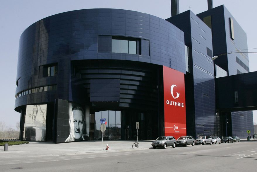 FILE - In a April 20, 2007 file photo, a portrait of Sir Tyrone Guthrie, lower left, graces the front of the new Guthrie Theater, in Minneapolis. The Minneapolis theater announced seven of its upcoming nine productions Thursday, March 2, 2017. The Guthrie Theater's new season will explore contemporary issues such as race relations and cultural assimilation. (AP Photo/Jim Mone, File)
