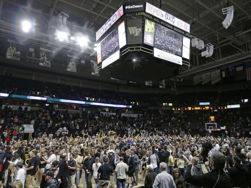 Wake Forest students, players and fans celebrates after an NCAA college basketball game against Louisville in Winston-Salem, N.C., Wednesday, March 1, 2017. Wake Forest won 88-81. (AP Photo/Chuck Burton)