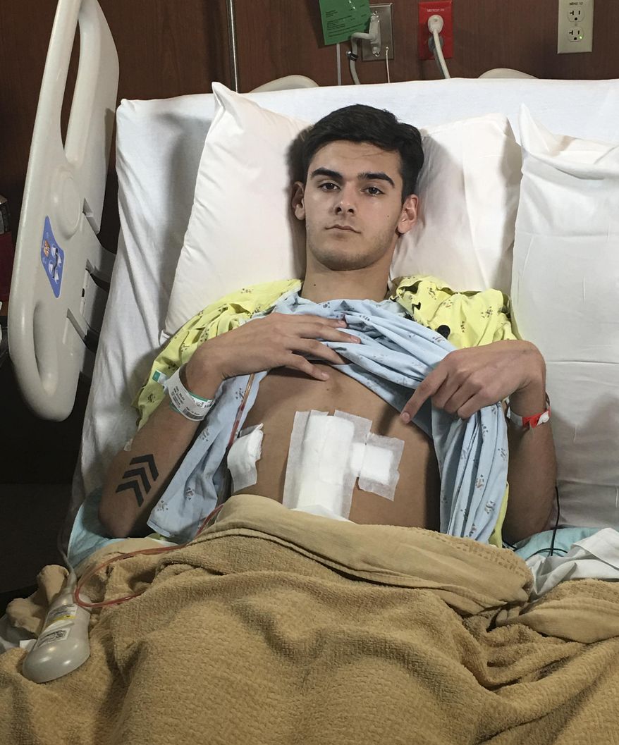 This photo provided by Via Christi Health shows convenience store clerk Riley Juel recuperating at the hospital in Wichita, Kan., Thursday, March 2, 2017, a day after being shot by a fugitive on a multi-state crime spree. Alex Deaton was arrested Wednesday near Wilson, Kan., suspected of killing two people in Mississippi and shooting another in New Mexico and Juel in Kansas before he was captured. (Maria Loving/Via Christi Health via AP)