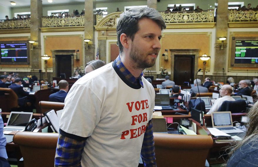 Actor and producer Jon Heder leaves the Utah House floor after speaking with the representatives at the Utah State Capitol Thursday, March 2, 2017, in Salt Lake City. The star of 2004 hit movie "Napoleon Dynamite" is telling lawmakers that Utah's film tax incentives are vital to luring productions to the state. Heder spoke briefly to the state's legislature on Thursday about how the tax credits could help him bring movies to Utah. He wore a "Vote For Pedro" T-shirt in a nod to a memorable shirt worn by Heder in the film. (AP Photo/Rick Bowmer)