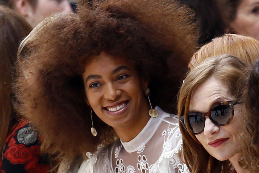 U.S singer Solange Knowles, left, and french actress Isabelle Huppert, right, look on prior to the show for Chloe's Fall-Winter 2017-2018 ready to wear fashion collection presented in Paris, Thursday, March 2, 2017. (AP Photo/Francois Mori)