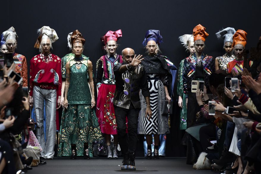 Indian fashion designer Manish Arora waves to the audience after his Fall-Winter 2017-2018 ready to wear fashion collection presented Thursday, March 2, 2017 in Paris. (AP Photo/Zacharie Scheurer)