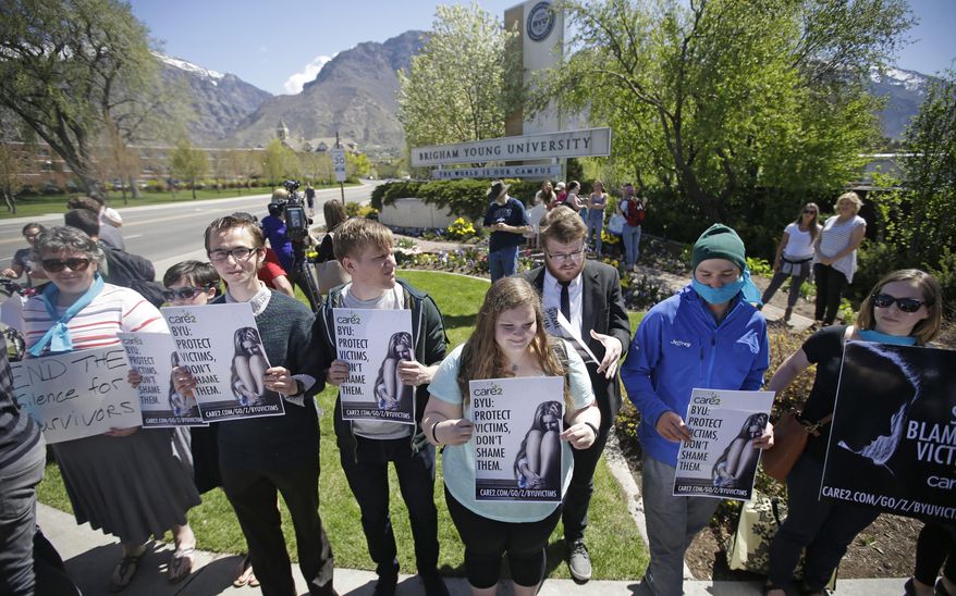 FILE - In this April 20, 2016, file photo, protesters stand in solidarity with rape victims on the campus of Brigham Young University during a sexual assault awareness demonstration in Provo, Utah. Utah lawmakers on Thursday, March 2, 2017, were expected to consider a bill requiring college counselors to keep sexual abuse reports confidential, almost one year after Mormon-owned Brigham Young University faced major backlash when it was revealed it shared assault victim information with its honor code office. The proposal by Romero, would also apply to student reports of domestic violence, sexual harassment and dating violence and was scheduled for review by a Senate law enforcement committee. (AP Photo/Rick Bowmer, File)