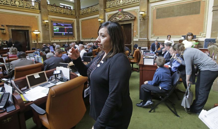 Rep. Angela Romero, D-Salt Lake City, walks across the House floor, at the Utah State Capitol Thursday, March 2, 2017, in Salt Lake City. Utah lawmakers on Thursday, March 2, 2017, were expected to consider a bill requiring college counselors to keep sexual abuse reports confidential, almost one year after Mormon-owned Brigham Young University faced major backlash when it was revealed it shared assault victim information with its honor code office. The proposal by Romero, would also apply to student reports of domestic violence, sexual harassment and dating violence and was scheduled for review by a Senate law enforcement committee. (AP Photo/Rick Bowmer)