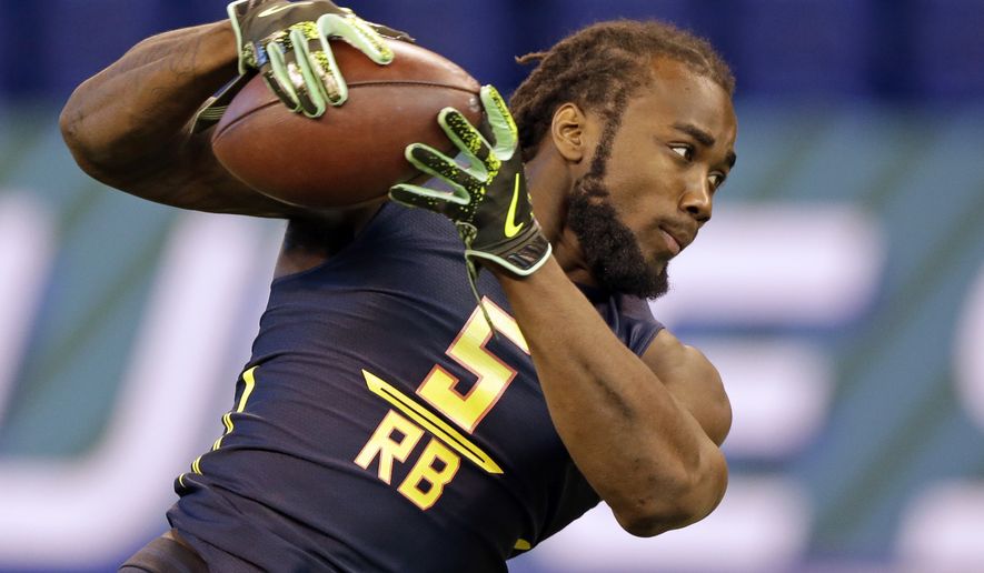 Florida State running back Dalvin Cook makes a catch as he runs a drill at the NFL football scouting combine in Indianapolis, Friday, March 3, 2017. (AP Photo/Michael Conroy)