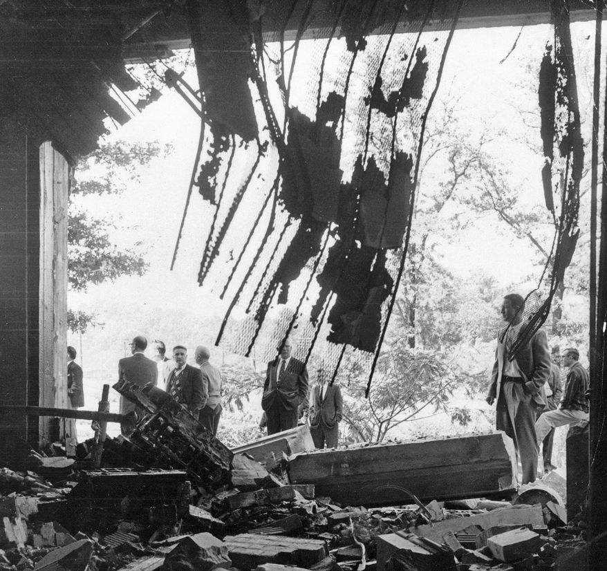 In this Oct. 13, 1958 file photo, authorities investigate the scene of damage from a bomb blast at The Temple on Peachtree Street in Atlanta. A few more hours and Sunday school classrooms at the temple would have been filled with 600 children. (Dwight Ross/Atlanta Journal-Constitution via AP, File)