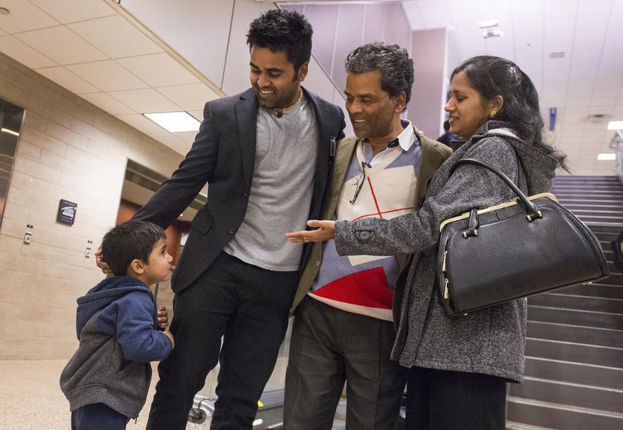 ADVANCE FOR THE WEEKEND OF MARCH 4-5 AND THEREAFTER - In a Feb. 21, 2017 photo, Kunal Sah, 23, introduces his son Keshav, 3, to his father Ken for the first time in Salt Lake City. Ken Sah is back in the U.S. for the first time in over 10 years at the Salt Lake International Airport. Sarita Sah arrived in Utah three weeks ago, ahead of her husband. Kunal's parents, Ken and Sarita, were forced to leave the country in 2006 after losing their legal battle with U.S. Immigration authorities. Kunal has been running the family's hotel business in Green River since 2011, trying to keep his parents' dream alive without them. (Leah Hogsten/The Salt Lake Tribune via AP)