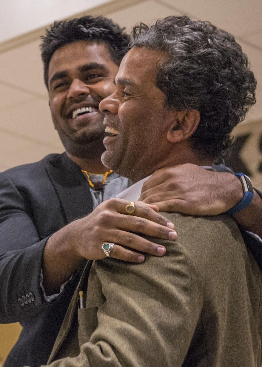 ADVANCE FOR THE WEEKEND OF MARCH 4-5 AND THEREAFTER - In a Feb. 21, 2017 photo, Kunal Sah, 23, welcomes his father, Ken Sah, back to the U.S. for the first time in over 10 years at the Salt Lake International Airport. Ken and Sarita, were forced to leave the country in 2006 after losing their legal battle with U.S. Immigration authorities. Kunal has been running the family's hotel business in Green River since 2011, trying to keep his parents' dream alive without them. (Leah Hogsten/The Salt Lake Tribune via AP)