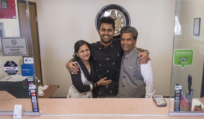 ADVANCE FOR THE WEEKEND OF MARCH 4-5 AND THEREAFTER - In a Feb. 21, 2017 photo, Kunal, Sarita and Ken Sah are reunited again at the hotel they built in 2001 after living some 10 years apart. Kunal's parents, Ken and Sarita Sah, were forced to leave the country in 2006 after losing their legal battle with U.S. Immigration authorities. Kunal has been running the family's hotel business in Green River since 2011, trying to keep his parents' dream alive without them.  (Leah Hogsten/The Salt Lake Tribune via AP)