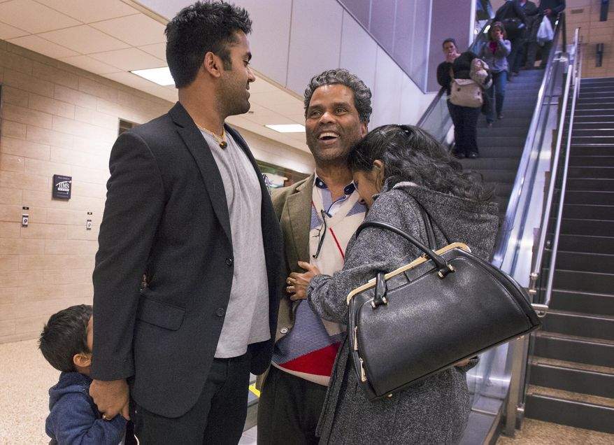 ADVANCE FOR THE WEEKEND OF MARCH 4-5 AND THEREAFTER - In a Feb. 21, 2017 photo, Kunal Sah, 23, welcomes his father, Ken Sah, back to the U.S. for the first time in over 10 years at the Salt Lake International Airport. Sarita Sah arrived in Utah three weeks ago, ahead of her husband. Kunal's parents, Ken and Sarita, were forced to leave the country in 2006 after losing their legal battle with U.S. Immigration authorities. Kunal has been running the family's hotel business in Green River since 2011, trying to keep his parents' dream alive without them. (Leah Hogsten/The Salt Lake Tribune via AP)