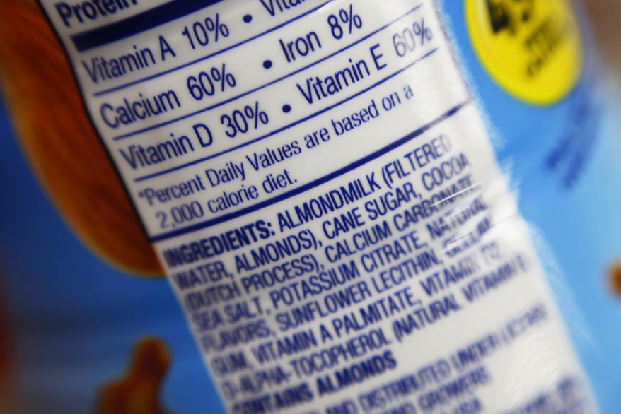 This Thursday, Feb. 16, 2017, photo shows the ingredients label for almond milk at a grocery store in New York. Dairy producers are calling for a crackdown on the almond, soy and rice “milks” they say are masquerading as the real thing and cloud the meaning of milk for shoppers. A group that advocates for plant-based products has countered by asking the Food and Drug Administration to say foods can use terms such as “milk” and “sausage,” so long as they’re modified to make clear what’s in them. (AP Photo/Patrick Sison)