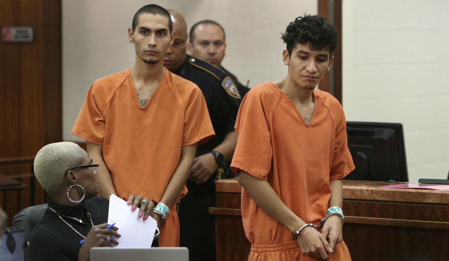 Two known MS-13 gang members, formerly of El Salvador, Miguel Alvarez-Flores, right, and Diego Hernandez-Rivera appear in court Thursday, March 2, 2017, in Houston. The pair, who had a Satanic shrine in their Houston apartment, are suspects in the killing of one teenager and the kidnapping of another. (Steve Gonzales/Houston Chronicle via AP) **FILE**