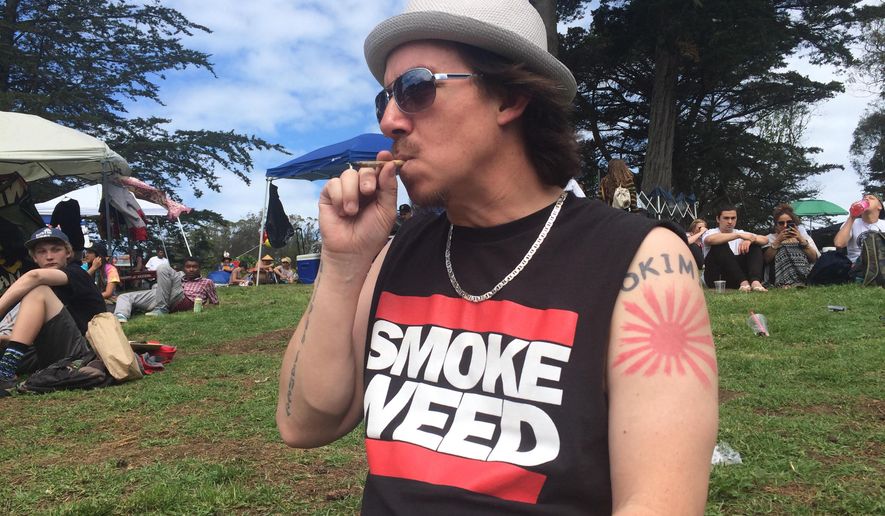FILE--In this April 20, 2016, Shane Kinoshita smokes marijuana in Golden Gate Park as people gather at the park to smoke pot for the annual 4/20 celebration in San Francisco, Calif. A first-ever event sponsored this weekend by High Times magazine at a tribal events center near Las Vegas, Nev., will be smokeless after a U.S. attorney in Nevada warned the host Moapa Band of Paiutes that federal law applies on Indian reservations--the tribe declared that smoking, selling, trading and transporting marijuana won&#39;t be allowed. (AP Photo/Haven Daley, file)