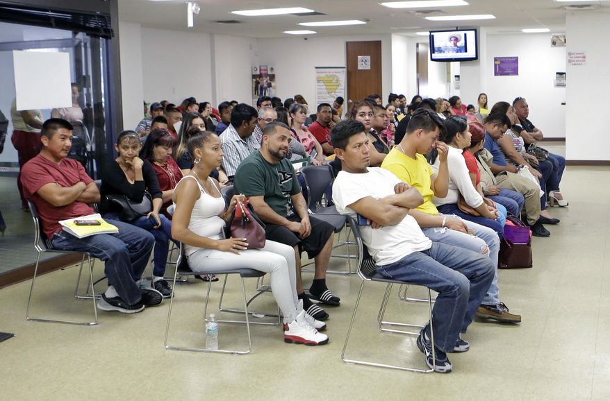 Mexican nationals wait to be seen at the Consulate General of Mexico, Friday, March 3, 2017, in Miami. The Mexican government is beefing up its aid to migrants in the U.S. through the creation of 50 legal assistance centers in response to President Donald Trump's measures to curb illegal immigration. (AP Photo/Alan Diaz)