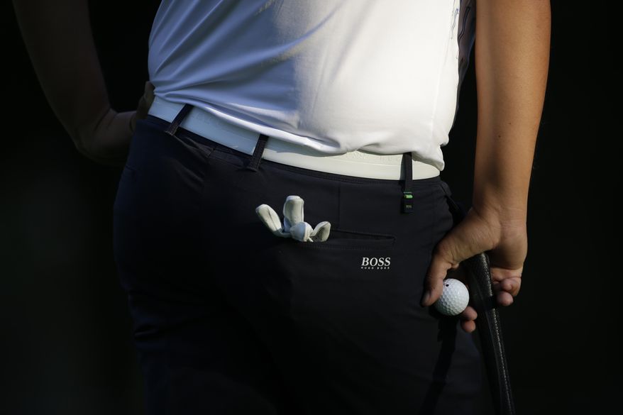 Byeong Hun An, of South Korea, holds a golf ball as he waits his turn to putt on the 9th hole, in round one of the Mexico Championship at Chapultepec Golf Club in Mexico City, Thursday, March 2, 2017. All but one of the world's top 50 golfers are contesting the World Golf Championship PGA event, which this year relocated to Mexico City from the Trump National Doral Resort in Florida. (AP Photo/Rebecca Blackwell)
