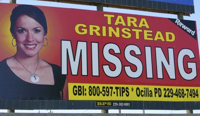 FILE - In this Wednesday, Oct. 4, 2006, file photo, missing teacher Tara Grinstead is displayed on a billboard in Ocilla, Ga. Georgia Bureau of Investigation Special Agent in Charge J.T. Ricketson tells multiple news outlets that investigators returned to a pecan farm Wednesday, March 1, 2017, searching for Grinstead’s remains. Investigators dug through a wooded area Tuesday for Grinstead, who went missing from her Ocilla home in 2005. (AP Photo/Elliott Minor, File)