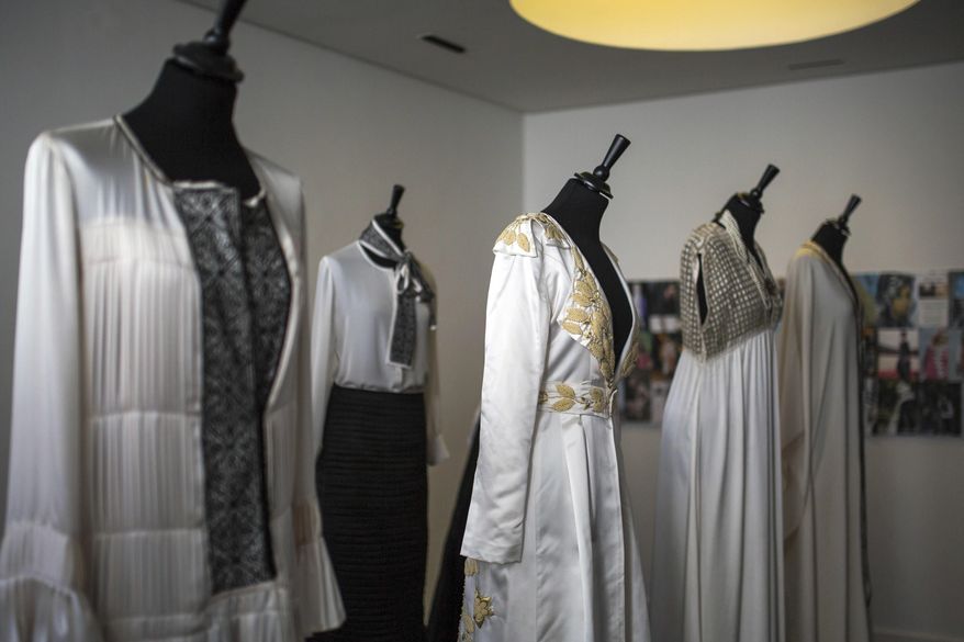 In this photo dated Tuesday, Feb. 28, 2017, dresses designed by Moroccan fashion designer Fadila El Gadi are displayed in her showroom, in Sale, near Rabat, Morocco. A globally successful Moroccan fashion designer returned to her hometown and founded an unusual sewing school aimed at helping poor, troubled children find a path, in a country where youth unemployment is high and the lure of extremism lurks. (AP Photo/Mosa'ab Elshamy)