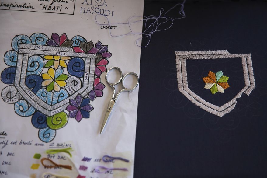 In this photo dated Tuesday, Feb. 28, 2017, a pattern is displayed next to a half-finished cloth, at an informal school run by Moroccan fashion designer Fadila El Gadi, in Sale, near Rabat, Morocco. A globally successful Moroccan fashion designer returned to her hometown and founded an unusual sewing school aimed at helping poor, troubled children find a path, in a country where youth unemployment is high and the lure of extremism lurks. (AP Photo/Mosa'ab Elshamy)