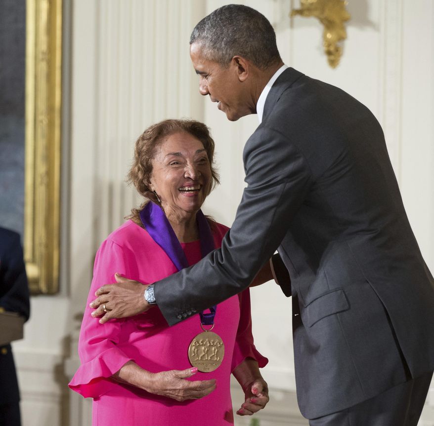 FILE - In this Sept. 10, 2015, file photo, President Barack Obama awards the 2014 National Medal of Arts to actress, theater founder, and director Miriam Colon of New York during a ceremony in the East Room at the White House in Washington. Colon, an icon in U.S. Latino theater who starred in films alongside Marlon Brando and Al Pacino, has died at age 80. Her husband, Fred Valle, told The Associated Press that Colon died early Friday, March 3, 2017, because of complications from a pulmonary infection. (AP Photo/Andrew Harnik, File)