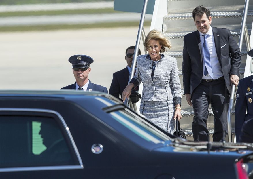 Secretary of Education, Betsy DeVos arrives in along with President Donald Trump in Air Force One at Orlando International Airport in Orlando, Fla., Friday, March 3, 2017. (AP Photo/Willie J. Allen Jr.)