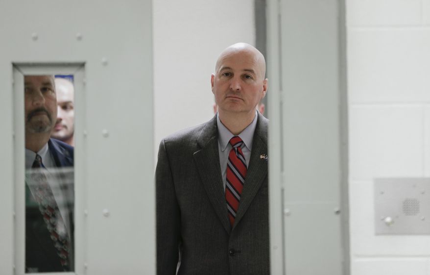 Nebraska corrections director Scott Frakes, left, and Nebraska Gov. Pete Ricketts walk through a security door at the Tecumseh State Correctional Institution in Tecumseh, Neb., Thursday, March 2, 2017. The prison has been placed on lockdown after dozens of inmates refused to return to their cells. (AP Photo/Nati Harnik)