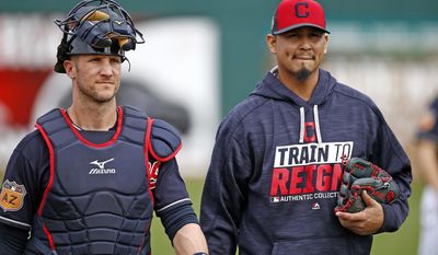 Cleveland Indians starting pitcher Carlos Carrasco, right, walks in from the bullpen with catcher Yan Gomes, left, after warming up for a spring training baseball game against the Colorado Rockies, Friday, March 3, 2017, in Goodyear, Ariz. (AP Photo/Ross D. Franklin)